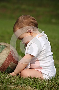 Baby girl sit at grass