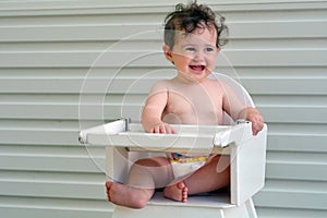 Baby girl sit on high chair