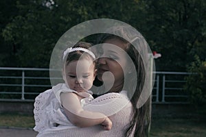 Baby girl sitting on the mom`s hands