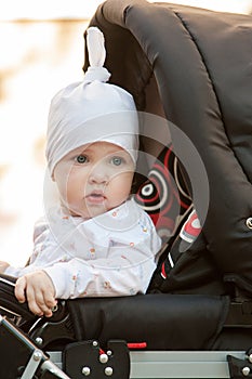 Baby girl sitting in a perambulator