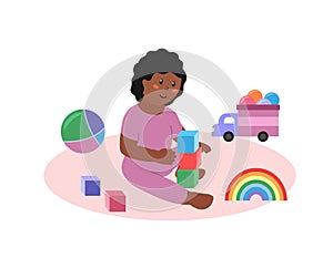 Baby girl sitting and playing toys isolated. Happy african american toddler child with cubes, car, ball and other colorful toys.