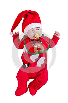 Baby girl sleeping or asleep with pacifier or dummy, red onesie, Rudolph reindeer bib, Santa hat for Christmas.