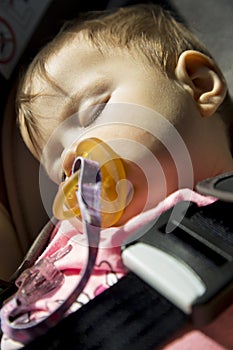 Baby girl sleeping in the car seat