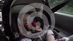 Baby Girl Sleeping in Child Car Seat.