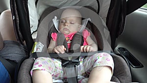 Baby Girl Sleeping in Child Car Seat.