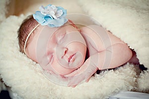 Baby girl sleeps on a blanket