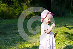 Baby girl smelling a flower