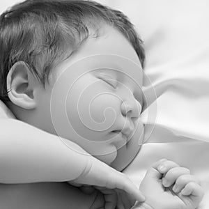 A Baby girl with Smily Face During Sleep. Little baby girl sleeping on white blanket. Beautiful portrait of