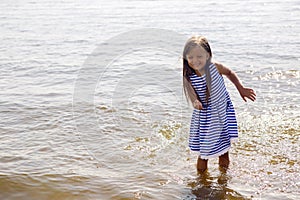 Baby girl in a striped dress and runs