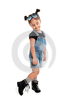 Baby girl with sunglasses posing in studio.Isolated
