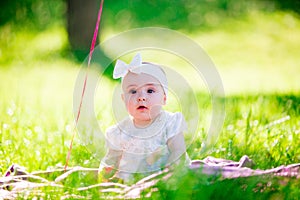 Baby girl on a sunny meadow portrait