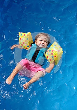 Baby girl in swimming pool