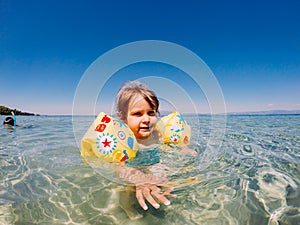 Baby girl swimming in sea