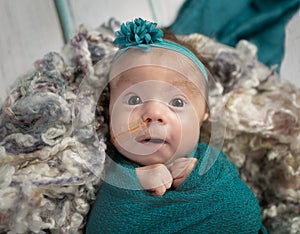 Baby girl in teal with feeding tube