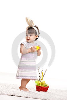 Baby girl with toy chicken