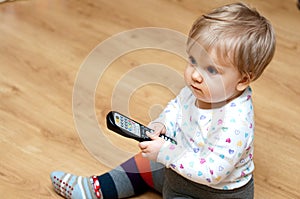 Baby girl with TV remote