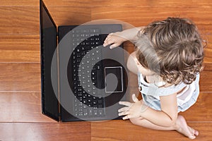 Baby girl using a laptop computer