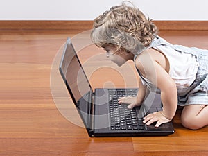 Baby girl using a laptop computer