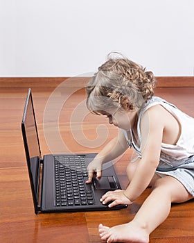 Baby girl using a laptop computer