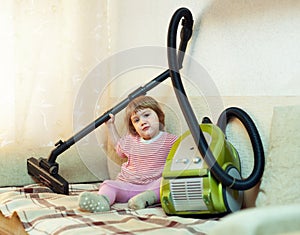 Baby girl with vacuum cleaner