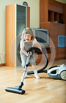 Baby girl with vacuum cleaner