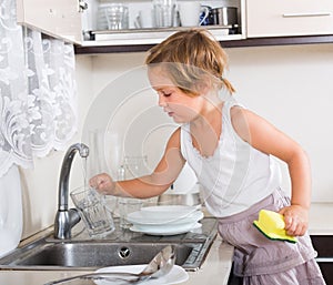 Baby girl washing dishes