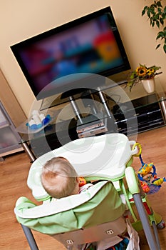 Baby girl watching tv photo