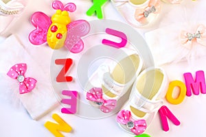 Baby girl wear accessories and toys on the whiite table photo