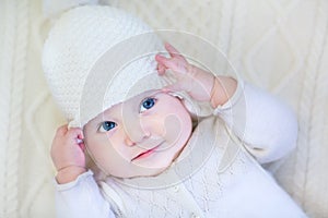 Baby girl wearing knitted sweater and hat