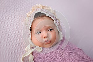 Baby Girl Wearing a Lace Bonnet
