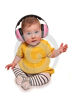 Baby girl wearing pink ear defenders