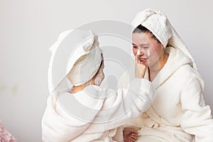 mother and daughter in bathrobes at home