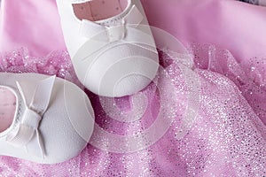 Baby girl white dancing shoes near leotards photo