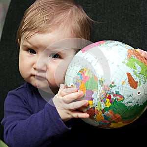 Baby girl with world globe