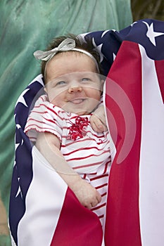 Baby girl wrapped in American flag