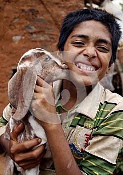 Baby Goat kissing a boy