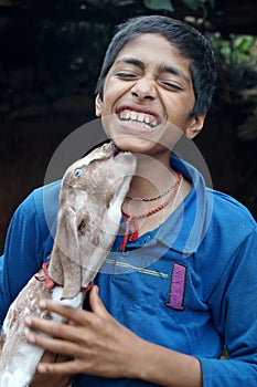 Baby Goat kissing a boy