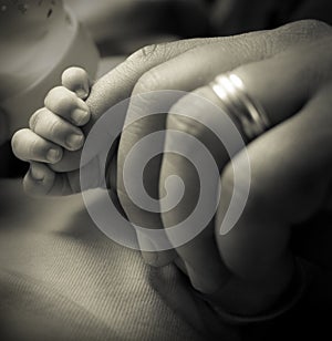 Baby grabbing dad's finger