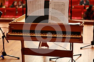 Baby grand piano, piano keys, golden piano keys on an old baroque clavichord