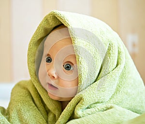 Baby with green towel