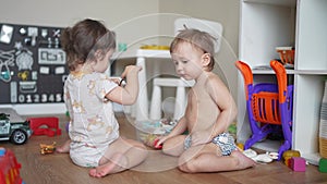 Baby group children playing toys animals on the floor in kindergarten. Happy family kid concept. Baby twins play toys