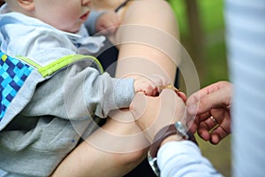 Baby hand holding mother