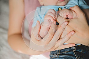 Baby hand holding mother