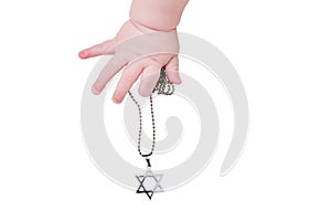 Baby hand and Jewish religious symbol is the star of David, close-up, is