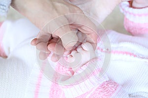 Baby hand in parents hands, close up