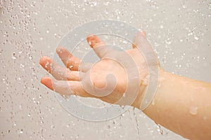 Baby hand with running water