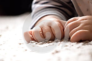 Baby hand on soft carpet