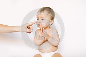 Baby handling: Woman applying moisturizing cream on her baby`s face