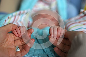 Baby hands with father photo