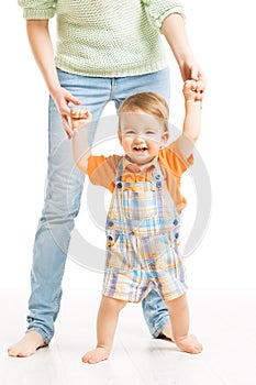 Baby happy go first steps. Mother helping child